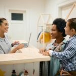 A woman and her son talk to their preschool teacher.